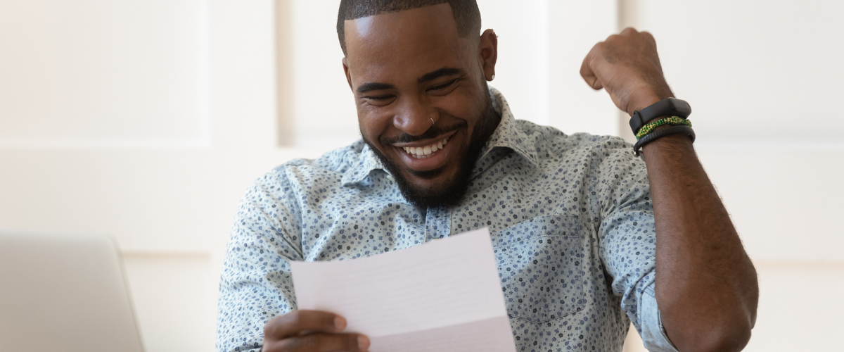 Man reading small business loan approval letter