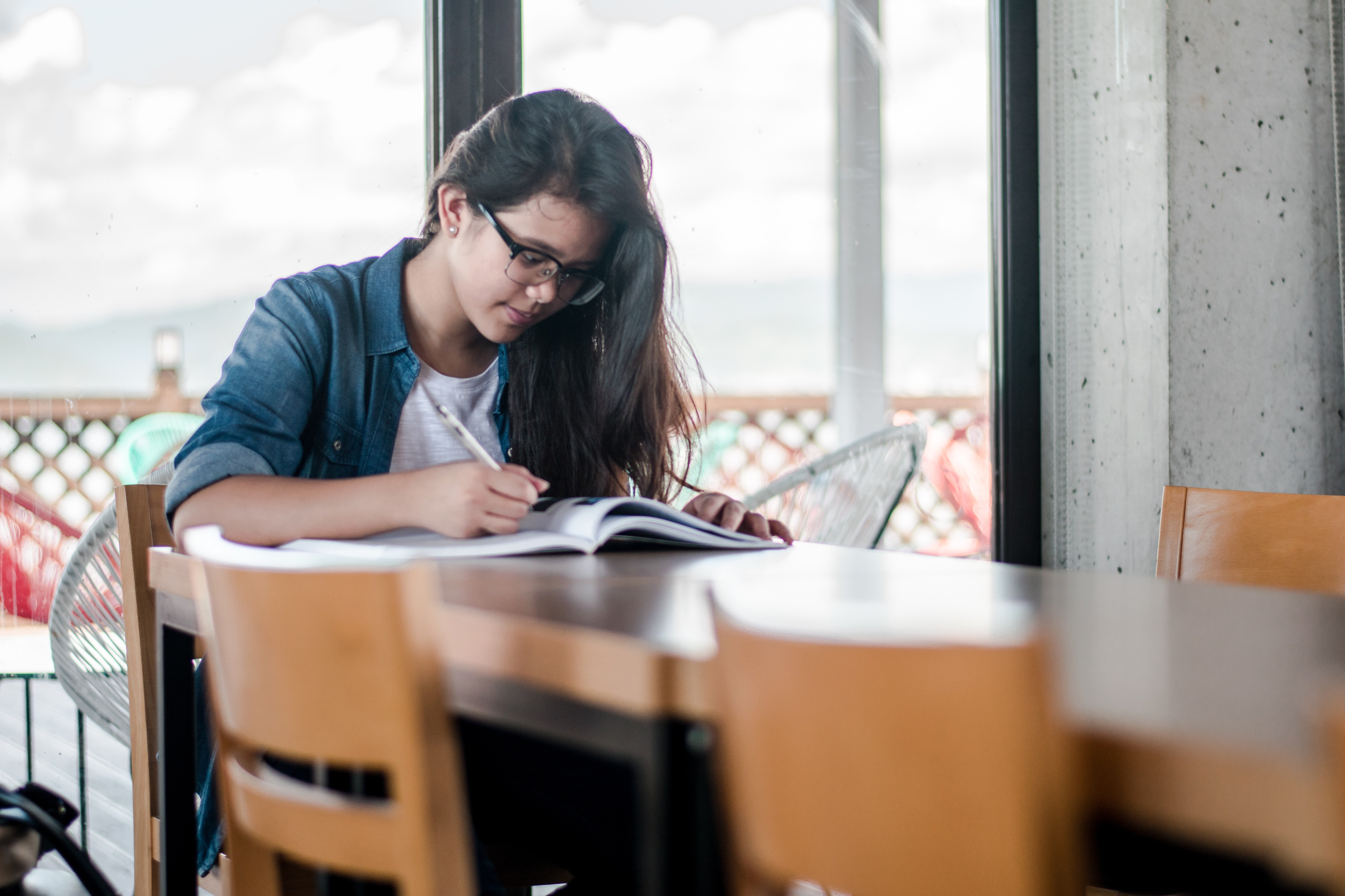 student at desk making financial goals