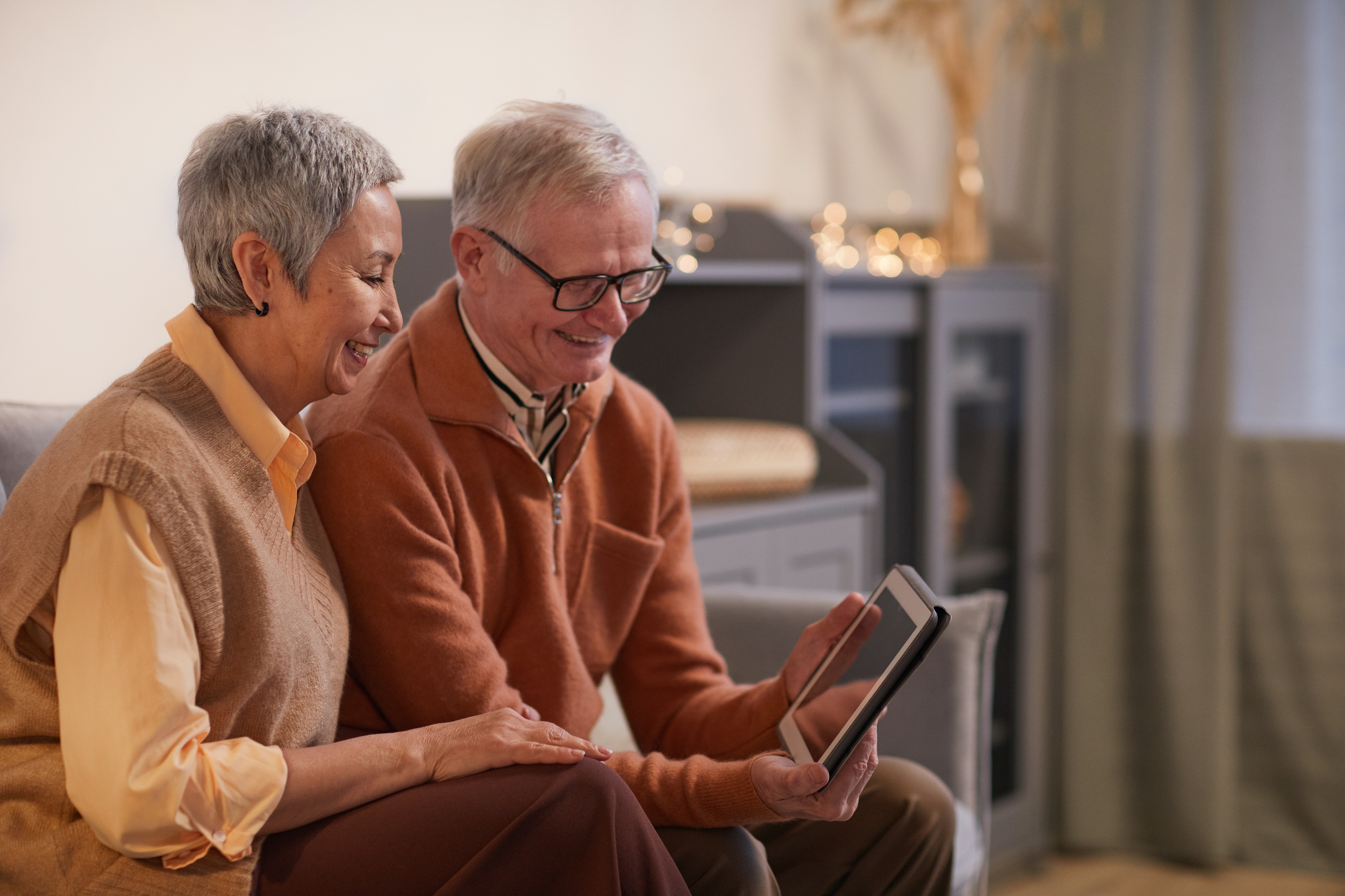 Elderly couple looking at finances on tablet