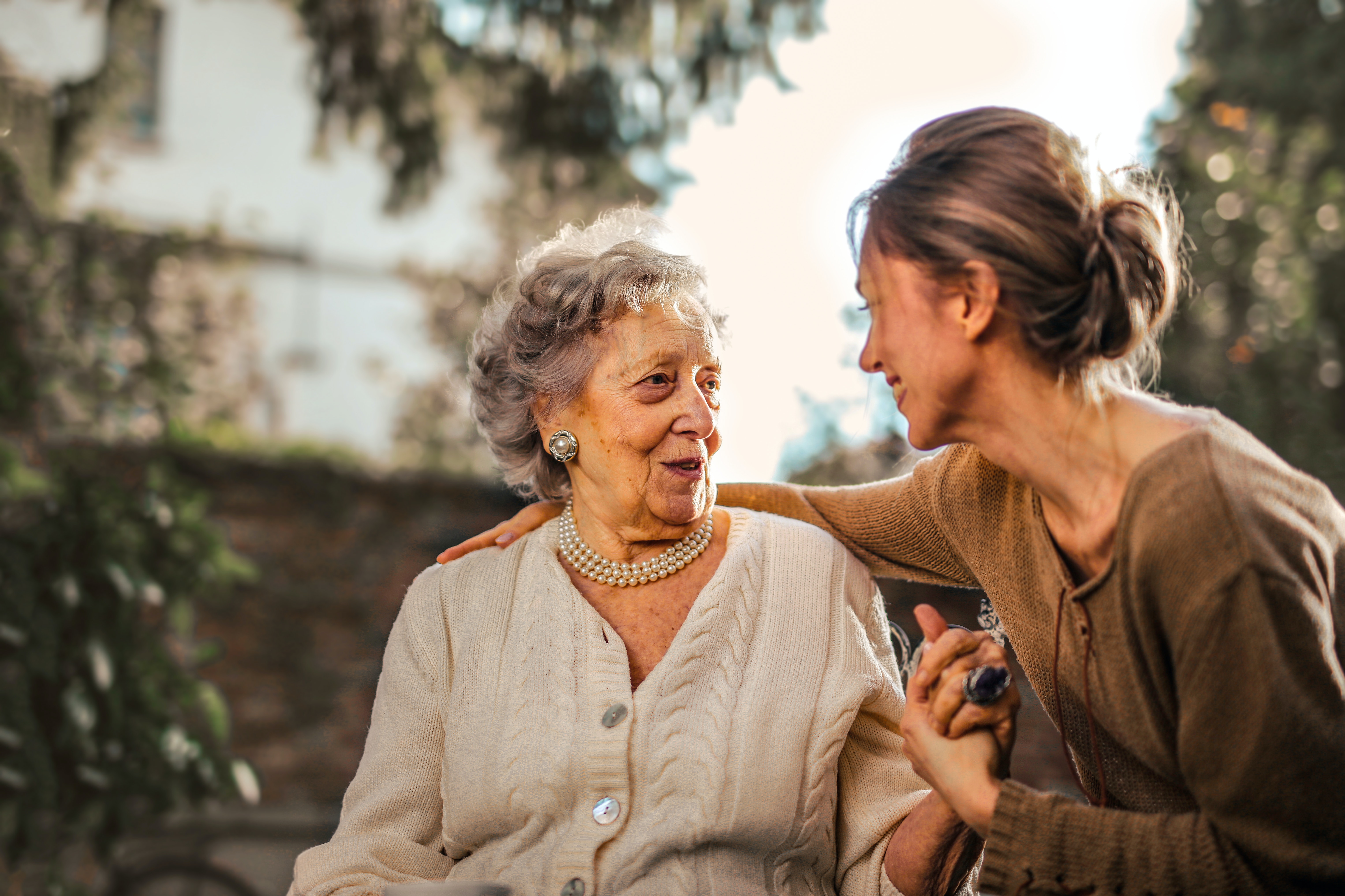 woman talking to elderly mother about finances