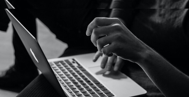 hands typing on laptop