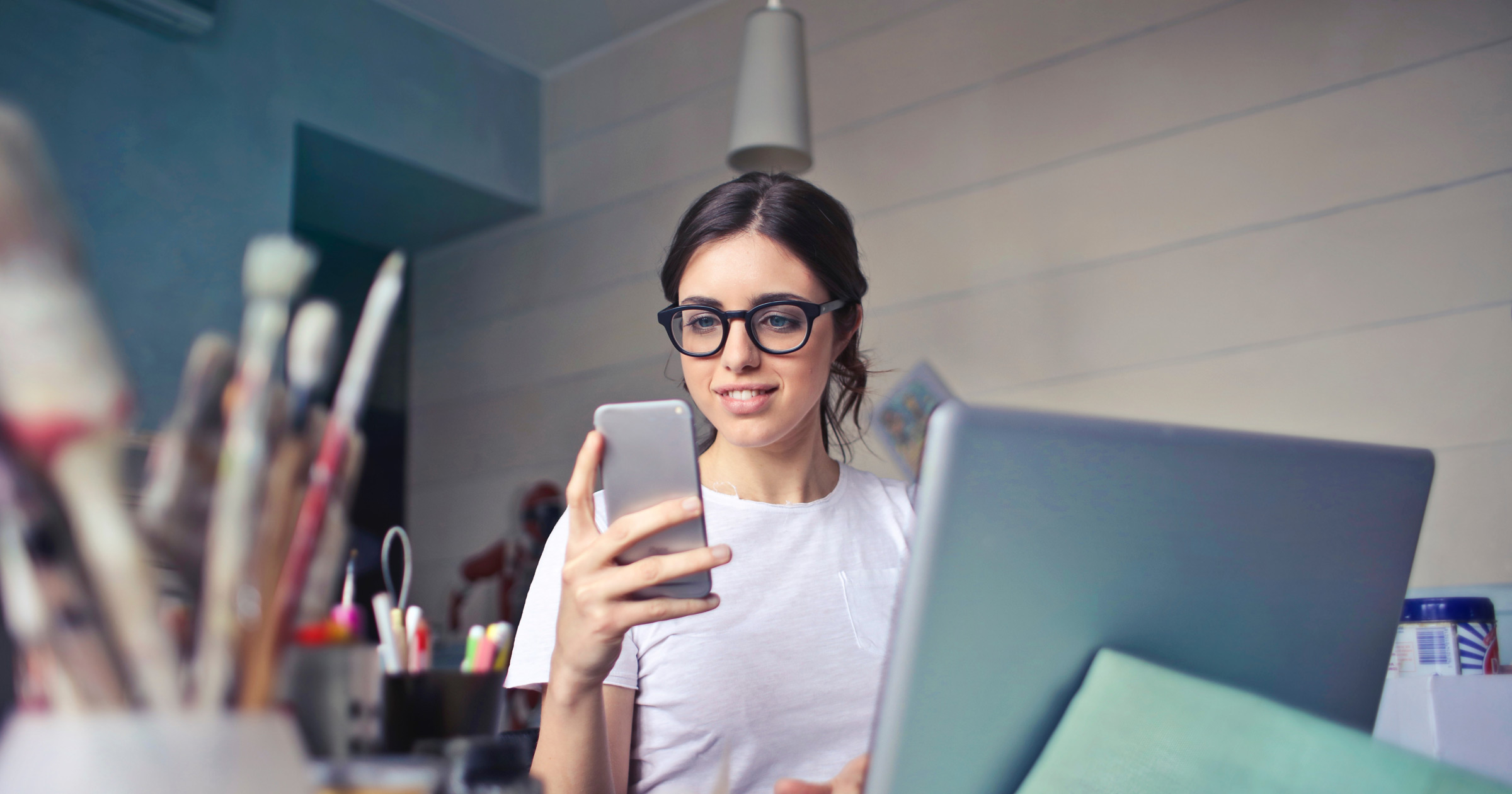 Woman smiling on phone at desk